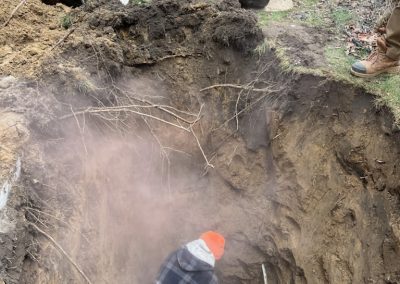 Worker is in the midst of a sewer line repair